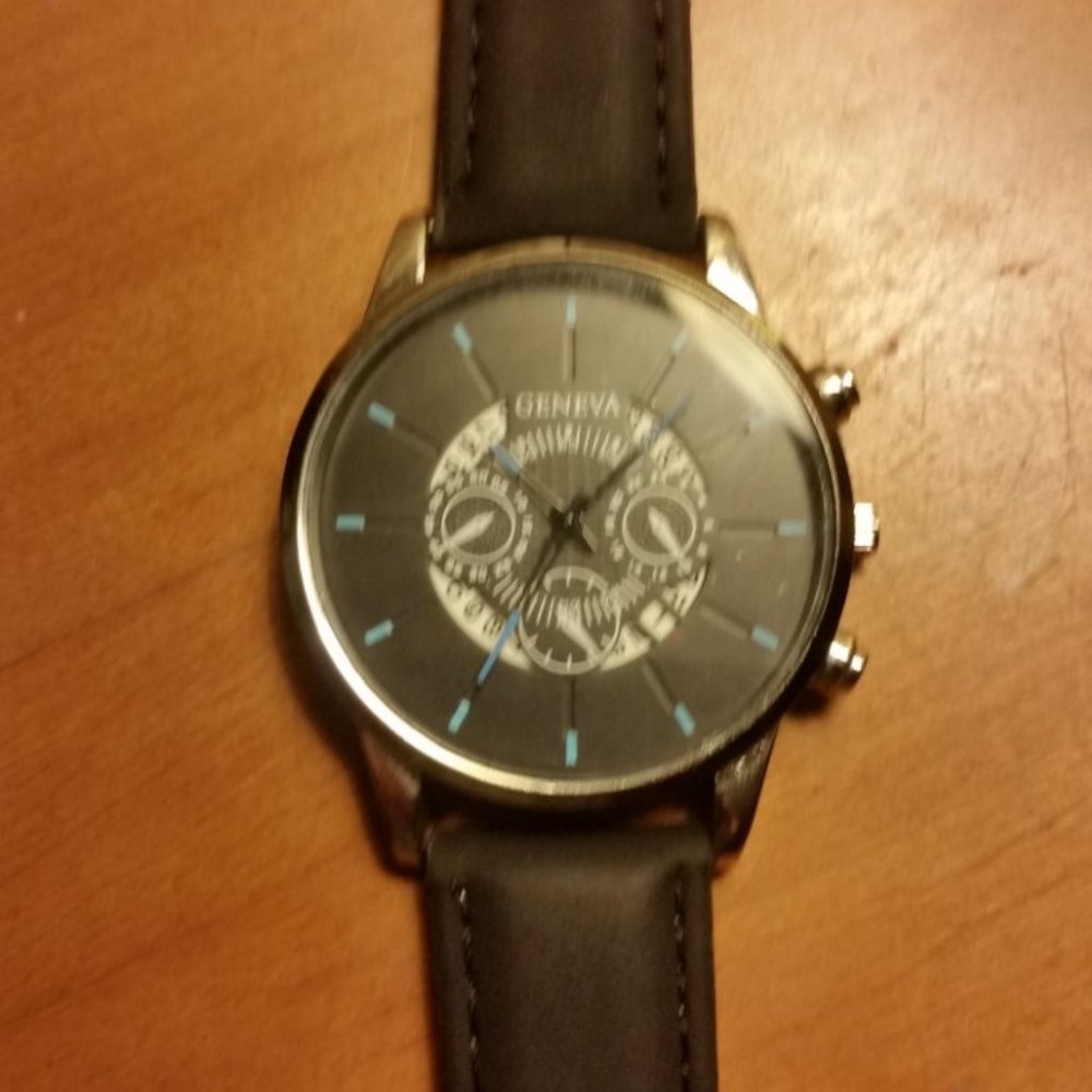 silver and black Geneva watch
